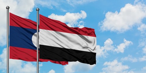 Laos and Yemen flag waving in the wind against white cloudy blue sky together. Diplomacy concept, international relations.