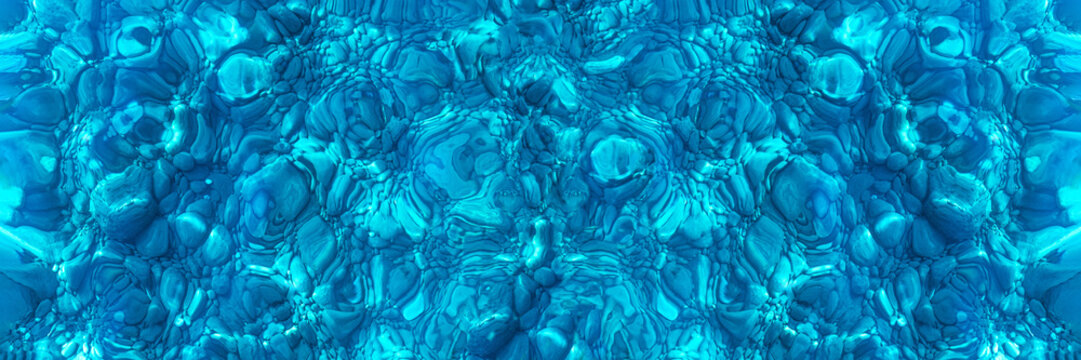 Seabed with pebbles through clear blue water, banner. Abstract blue background. Texture of the seabed, panorama. Surface of the seabed.