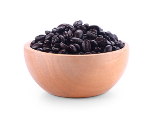 Wooden Bowl with coffee beans and coffee leaf on white background.