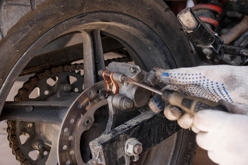 The process of replacing brake pads on a motorcycle.