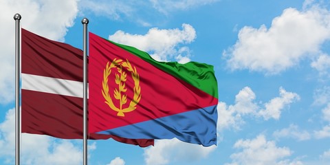 Latvia and Eritrea flag waving in the wind against white cloudy blue sky together. Diplomacy concept, international relations.