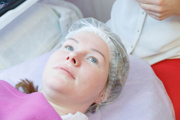 Woman on the procedure for eyelash extensions, eyelashes lamination