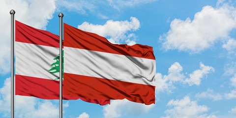 Lebanon and Austria flag waving in the wind against white cloudy blue sky together. Diplomacy concept, international relations.