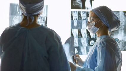 Two female women medical doctors looking at x-rays in a hospital