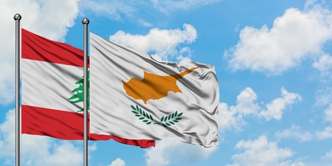 Lebanon and Cyprus flag waving in the wind against white cloudy blue sky together. Diplomacy...