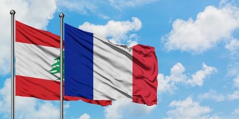 Lebanon and France flag waving in the wind against white cloudy blue sky together. Diplomacy concept, international relations.