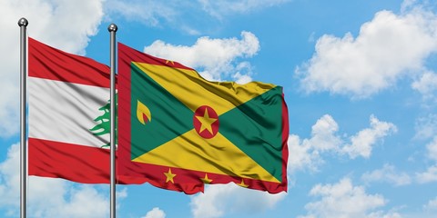 Lebanon and Grenada flag waving in the wind against white cloudy blue sky together. Diplomacy concept, international relations.