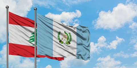 Lebanon and Guatemala flag waving in the wind against white cloudy blue sky together. Diplomacy concept, international relations.