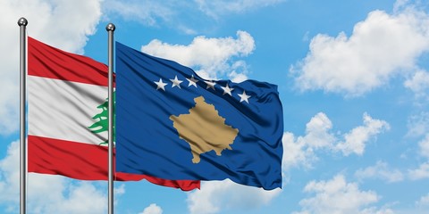 Lebanon and Kosovo flag waving in the wind against white cloudy blue sky together. Diplomacy concept, international relations.