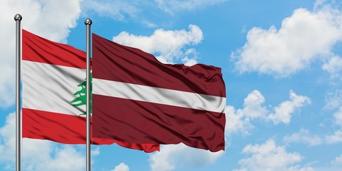 Lebanon and Latvia flag waving in the wind against white cloudy blue sky together. Diplomacy concept, international relations.
