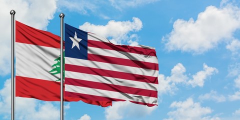 Lebanon and Liberia flag waving in the wind against white cloudy blue sky together. Diplomacy concept, international relations.