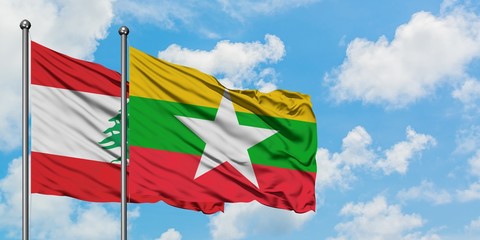Lebanon and Myanmar flag waving in the wind against white cloudy blue sky together. Diplomacy concept, international relations.