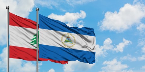 Lebanon and Nicaragua flag waving in the wind against white cloudy blue sky together. Diplomacy concept, international relations.