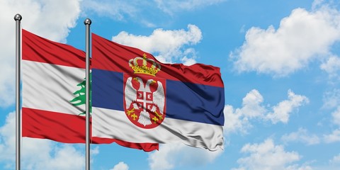 Lebanon and Serbia flag waving in the wind against white cloudy blue sky together. Diplomacy concept, international relations.