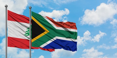 Lebanon and South Africa flag waving in the wind against white cloudy blue sky together. Diplomacy concept, international relations.