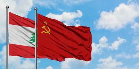 Lebanon and Soviet Union flag waving in the wind against white cloudy blue sky together. Diplomacy concept, international relations.