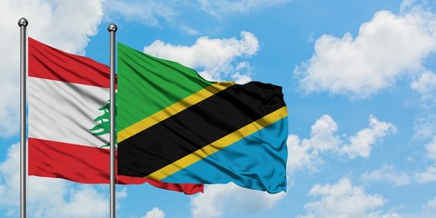 Lebanon and Tanzania flag waving in the wind against white cloudy blue sky together. Diplomacy concept, international relations.