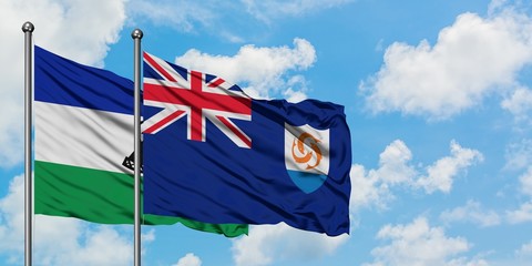 Lesotho and Anguilla flag waving in the wind against white cloudy blue sky together. Diplomacy concept, international relations.