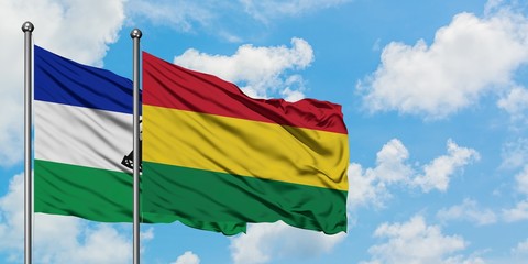 Lesotho and Bolivia flag waving in the wind against white cloudy blue sky together. Diplomacy concept, international relations.