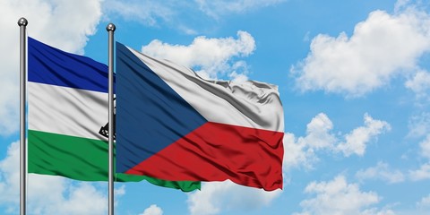 Lesotho and Czech Republic flag waving in the wind against white cloudy blue sky together. Diplomacy concept, international relations.