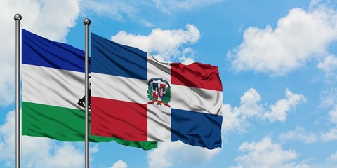 Lesotho and Dominican Republic flag waving in the wind against white cloudy blue sky together. Diplomacy concept, international relations.