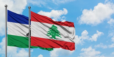 Lesotho and Lebanon flag waving in the wind against white cloudy blue sky together. Diplomacy concept, international relations.