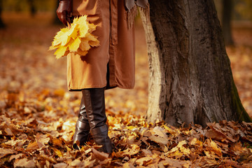 Closeup on woman with yellow leaves outdoors in autumn park