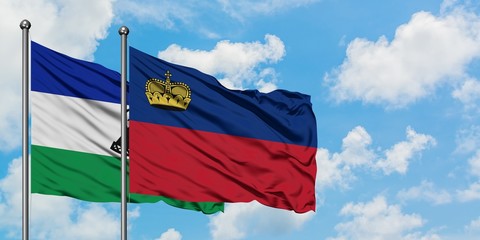 Lesotho and Liechtenstein flag waving in the wind against white cloudy blue sky together. Diplomacy concept, international relations.