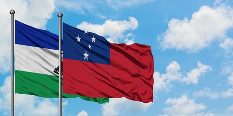 Lesotho and Samoa flag waving in the wind against white cloudy blue sky together. Diplomacy...