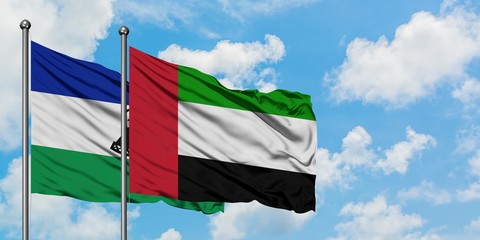 Lesotho and United Arab Emirates flag waving in the wind against white cloudy blue sky together. Diplomacy concept, international relations.