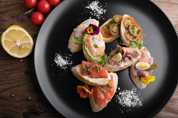 Brusquettes, Assorted, Fish, Prawns, Meat, Vegetables, Seafood, on a black background