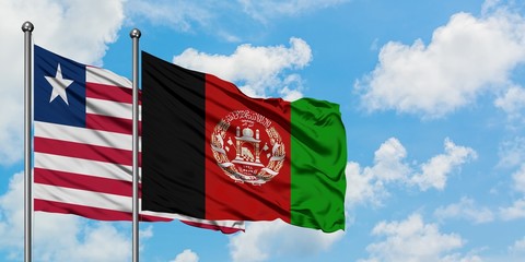 Liberia and Afghanistan flag waving in the wind against white cloudy blue sky together. Diplomacy concept, international relations.