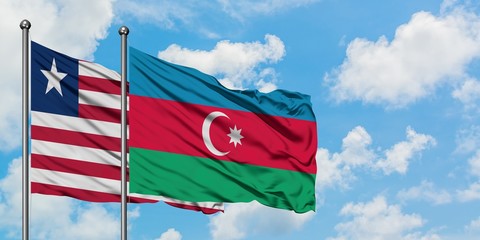Liberia and Azerbaijan flag waving in the wind against white cloudy blue sky together. Diplomacy concept, international relations.