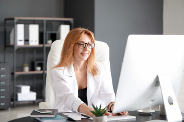 Portrait of mature businesswoman working in office