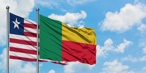 Liberia and Benin flag waving in the wind against white cloudy blue sky together. Diplomacy concept, international relations.