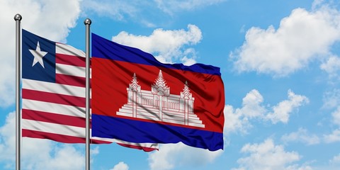 Liberia and Cambodia flag waving in the wind against white cloudy blue sky together. Diplomacy concept, international relations.