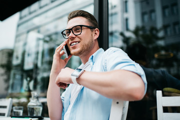 Cheerful man speaking on mobile phone