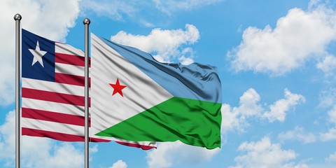 Liberia and Djibouti flag waving in the wind against white cloudy blue sky together. Diplomacy concept, international relations.