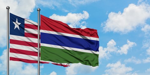 Liberia and Gambia flag waving in the wind against white cloudy blue sky together. Diplomacy concept, international relations.