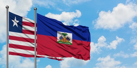 Liberia and Haiti flag waving in the wind against white cloudy blue sky together. Diplomacy concept, international relations.