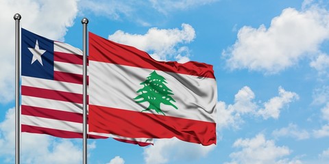 Liberia and Lebanon flag waving in the wind against white cloudy blue sky together. Diplomacy concept, international relations.