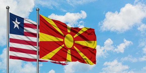 Liberia and Macedonia flag waving in the wind against white cloudy blue sky together. Diplomacy concept, international relations.