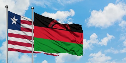 Liberia and Malawi flag waving in the wind against white cloudy blue sky together. Diplomacy concept, international relations.