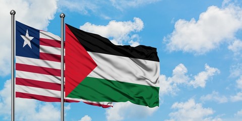 Liberia and Palestine flag waving in the wind against white cloudy blue sky together. Diplomacy concept, international relations.