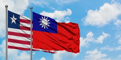 Liberia and Taiwan flag waving in the wind against white cloudy blue sky together. Diplomacy concept, international relations.