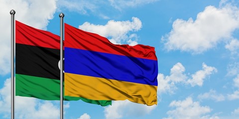 Libya and Armenia flag waving in the wind against white cloudy blue sky together. Diplomacy concept, international relations.