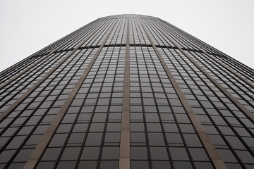 Low angle view skyscraper reflective glassy walls and windows background. Modern architecture pattern concept.
