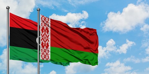 Libya and Belarus flag waving in the wind against white cloudy blue sky together. Diplomacy concept, international relations.