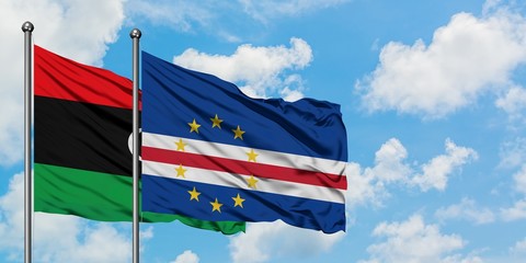 Libya and Cape Verde flag waving in the wind against white cloudy blue sky together. Diplomacy concept, international relations.