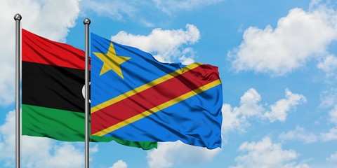 Libya and Congo flag waving in the wind against white cloudy blue sky together. Diplomacy concept, international relations.